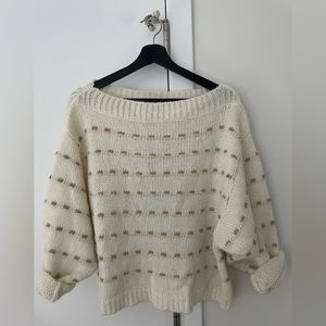 Off-the-shoulder white sweater